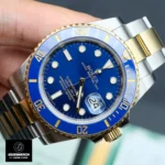 45-degree angle view of the Super Clone Rolex Submariner Blue Replica watch, featuring a blue bezel, blue dial, and a two-tone metal bracelet.