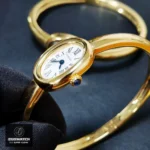 Close-up of the Cartier Baignoire Mini Dupe Watch, showcasing the gold case and side-mounted sapphire crown