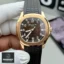 Handheld front view of the Super Clone Patek 5167R Aquanaut watch, featuring a rose gold case, brown dial, and brown rubber strap