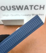 Patek Philippe Aquanaut Luce 5261R with blue composite strap — close-up showing strap texture and attachment to the case on a white background.