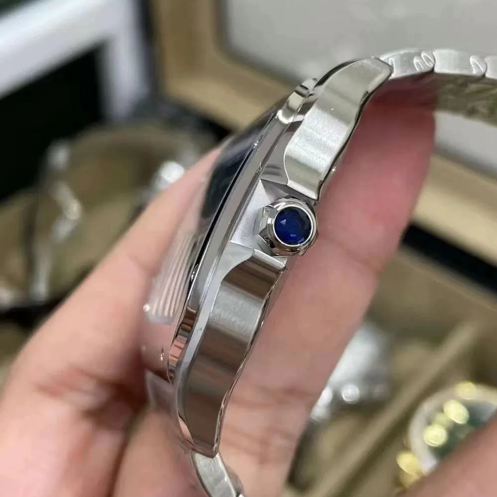 Holding Super Clone Cartier Santos Blue Dial WSSA0071 Watch Side View Showcasing the Blue Gem-Set Crown