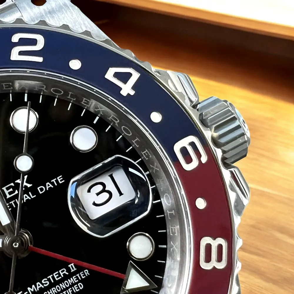 Super Clone Rolex Pepsi GMT bezel, date window, and crown