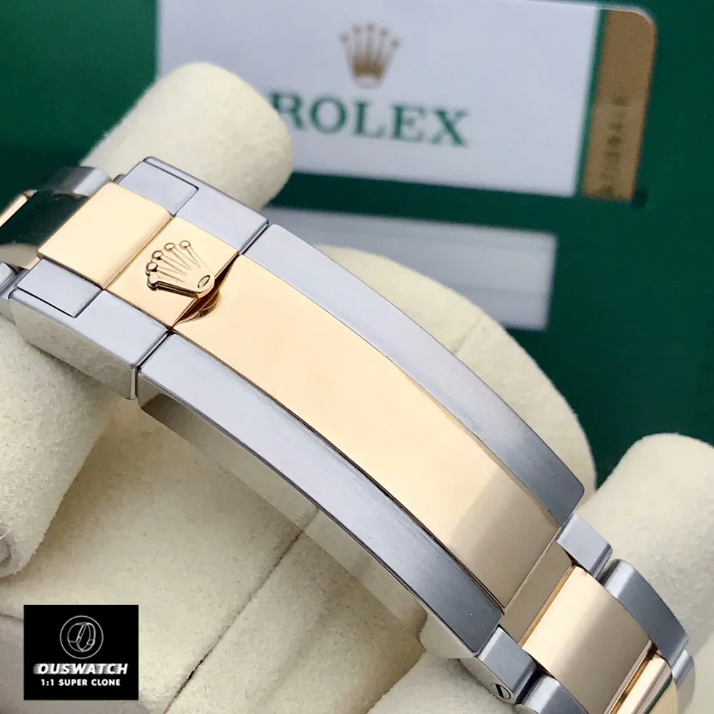 Detailed view of the two-tone metal clasp on the Super Clone Rolex Submariner Blue 116613lb watch.