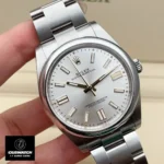 Replica Rolex Oyster Perpetual Silver 41mm watch at a 120-degree angle, showcasing the elegant silver dial and polished Oystersteel case.