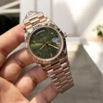 Replica Rolex 228235 Day Date 40 Rose Gold Watch at a 120-degree angle, highlighting the refined rose gold case and elegant Green dial.