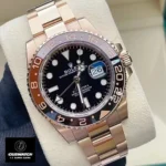 120-Degree View of the Rolex Everose Gold 126715CHNR Watch, Featuring the Rose Gold Case and Bracelet, Black Dial, and Brown & Black Ceramic Bezel.