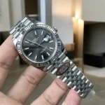 Replica Rolex Datejust Grey Dial 126334 Watch 120-degree angle showcasing the full design, including the polished bezel and grey dial.