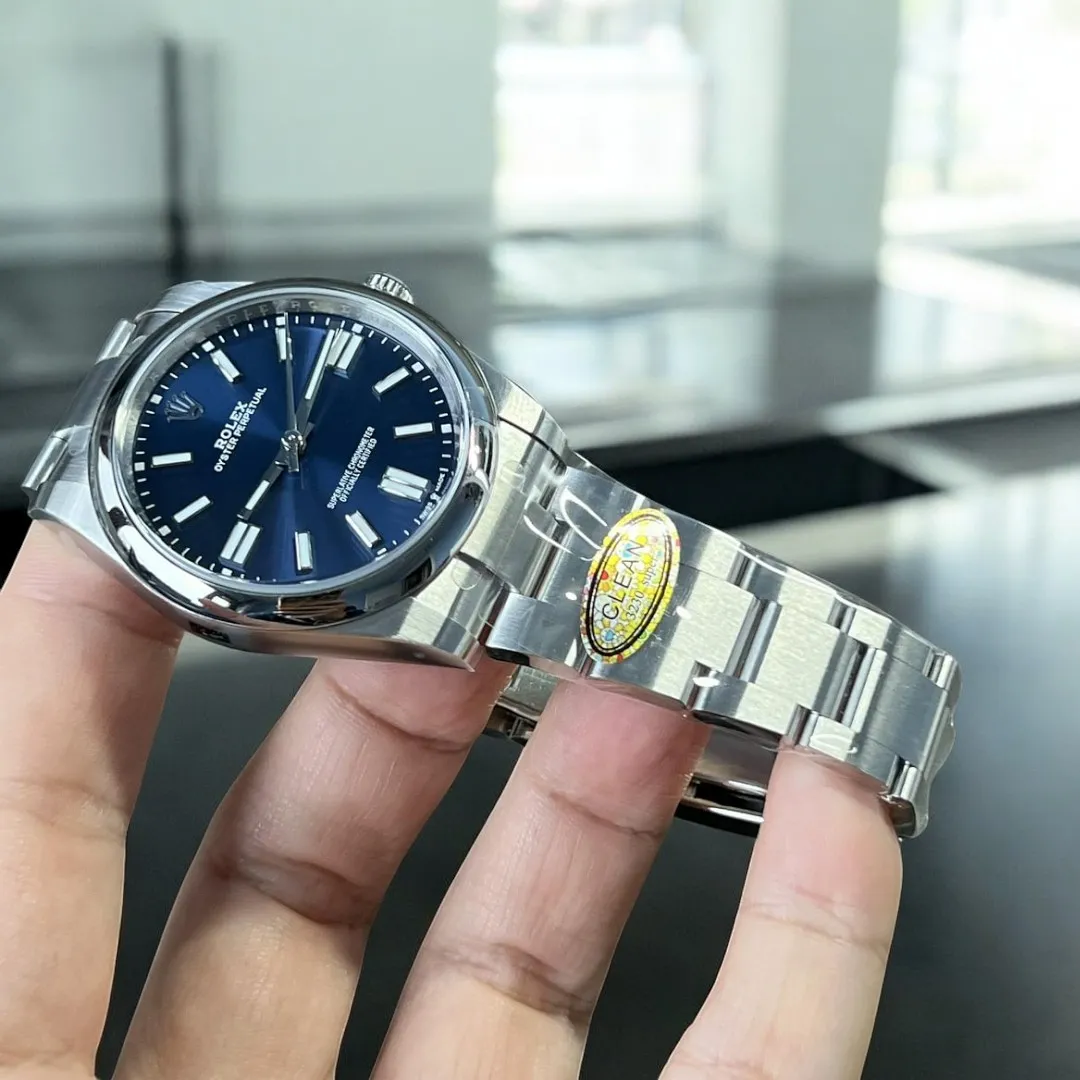 Replica Rolex Oyster Perpetual Blue m124300-0003 watch at a 130-degree angle, emphasizing the precision and high-quality craftsmanship of the blue dial and case.