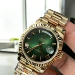 Top Replica Rolex 228238 Watch displayed at a 45-degree angle, focusing on the green dial and luxurious yellow gold case.