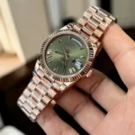 Replica Rolex Day Date Green Face m228235 Watch at a 75-degree angle, emphasizing the striking green dial and premium rose gold design.
