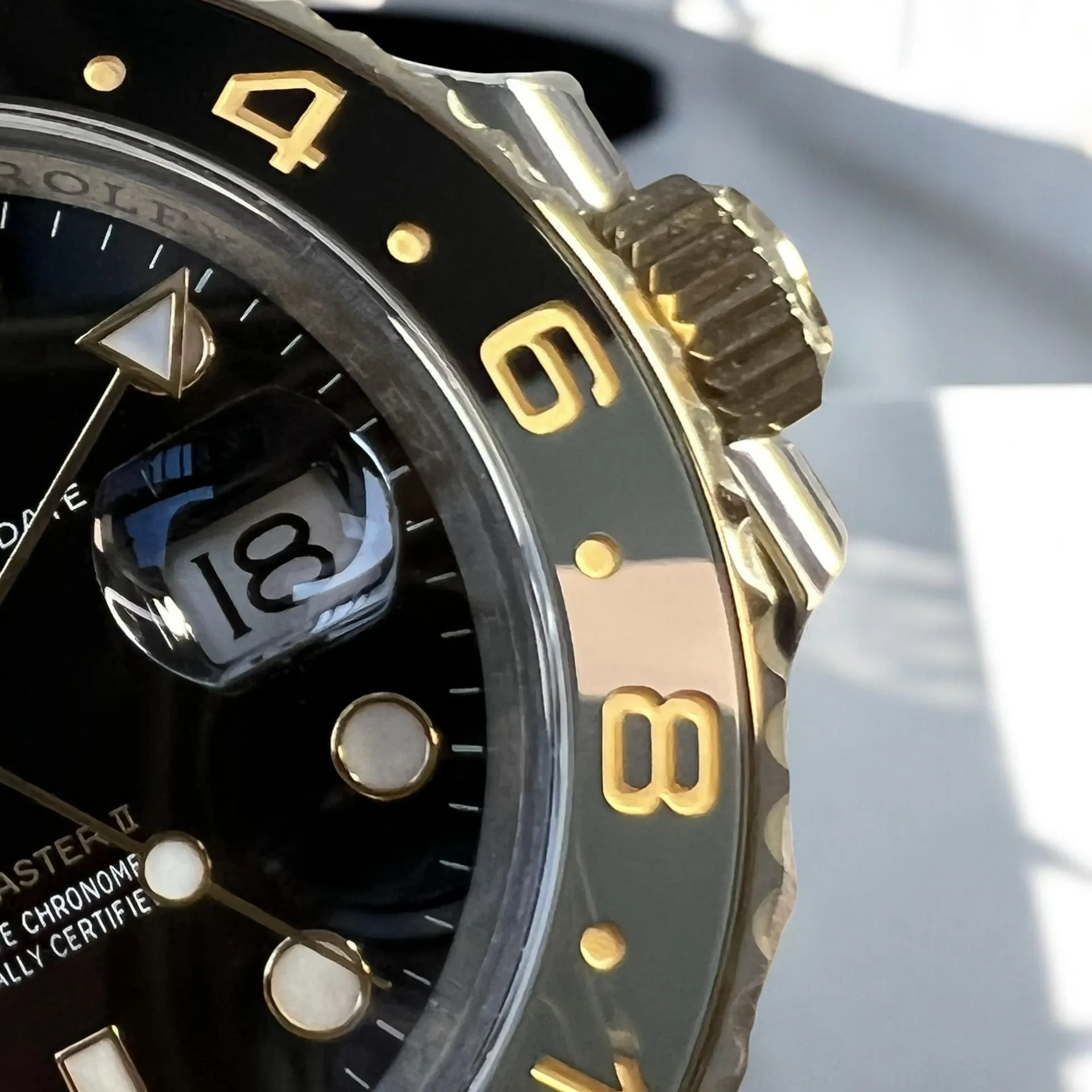 Super Clone Black Rolex GMT Master 126713GRNR Bezel Detail, with Yellow Gold Engraved Numbers on the Black Ceramic Bezel.