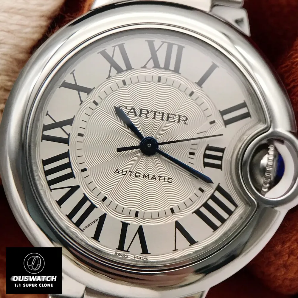 Close-up of the Cartier Ballon Bleu 33mm Watch dial, highlighting the silver guilloché pattern, Roman numerals, and blue sword-shaped hands.