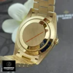 Replica Rolex 228238 Day Date 40 Presidential Watch back view, displaying the polished yellow gold case and intricate detailing.