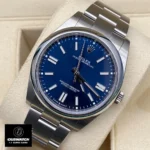 Replica Rolex Blue Face Oyster Perpetual 41 watch at a 45-degree angle, highlighting the elegant blue dial and Oystersteel case design.