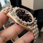 Super Clone Rolex Chocolate Dial Day Date 40 Watch side view, focusing on the sleek rose gold case and elegant design.