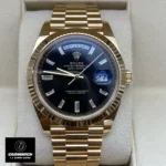 Replica Rolex Day Date 40 Black Dial M228238 Watch front view, showcasing the elegant black dial against a yellow gold case.