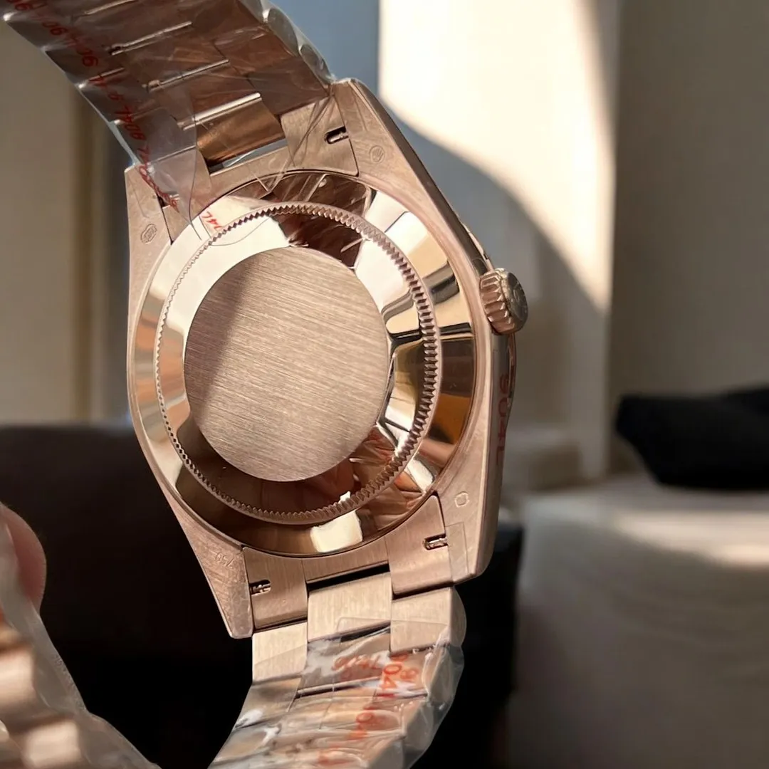 Replica Rolex Day Date Rose Gold 40 228235 Watch back view, highlighting the polished rose gold case and intricate design details.