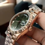 Replica Rolex Day Date Rose Gold 40MM Watch side view, focusing on the crown design and elegant rose gold finish.