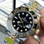 Super Clone Rolex GMT Two-Tone 126713GRNR Watch Black Dial Close-Up.