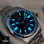 Replica Rolex Oyster Perpetual Blue Date m124300 watch showing the night display, featuring a striking blue dial and luminous markers, perfect for any occasion.