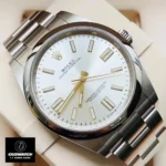 Replica Rolex Oyster Perpetual Silver Dial watch displayed at a 120-degree angle on a pillow