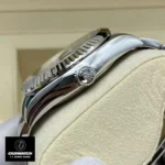 Replica Rolex Sky Dweller Blue Dial watch side view with a close-up of the Oyster case and signature crown.