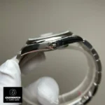 Replica Rolex Tiffany Blue Dial 124300 watch crown, focusing on the precision design and polished finish.