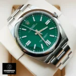 Replica Rolex watch with green face m124300 displayed at a 120-degree angle, showcasing the vibrant green dial and polished Oystersteel case.