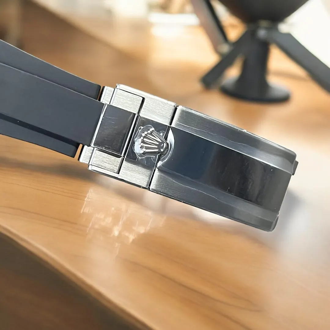 Close-up of the black rubber strap and clasp of the Rolex Yacht Master.