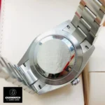 Replica Rolex with Green Face Oyster Perpetual m124300 watch back view, highlighting the fine craftsmanship of the Oystersteel case.