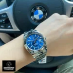 Wearing the Replica Rolex Blue Dial Sky Dweller watch, highlighting its elegance and luxurious style.
