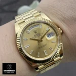 Replica Rolex 228238 Day Date 40 Gold Presidential Watch worn on the wrist, showcasing its elegant design and premium yellow gold finish.
