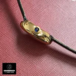 Close-up of Cartier Baignoire Mini Mode WGBA0017 watch dupe with signature blue sapphire crown