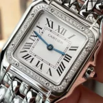 Close-up of the silvered dial on the Panthere de Cartier small model W4PN0016 super clone watch, featuring blued-steel sword-shaped hands and Roman numeral hour markers.