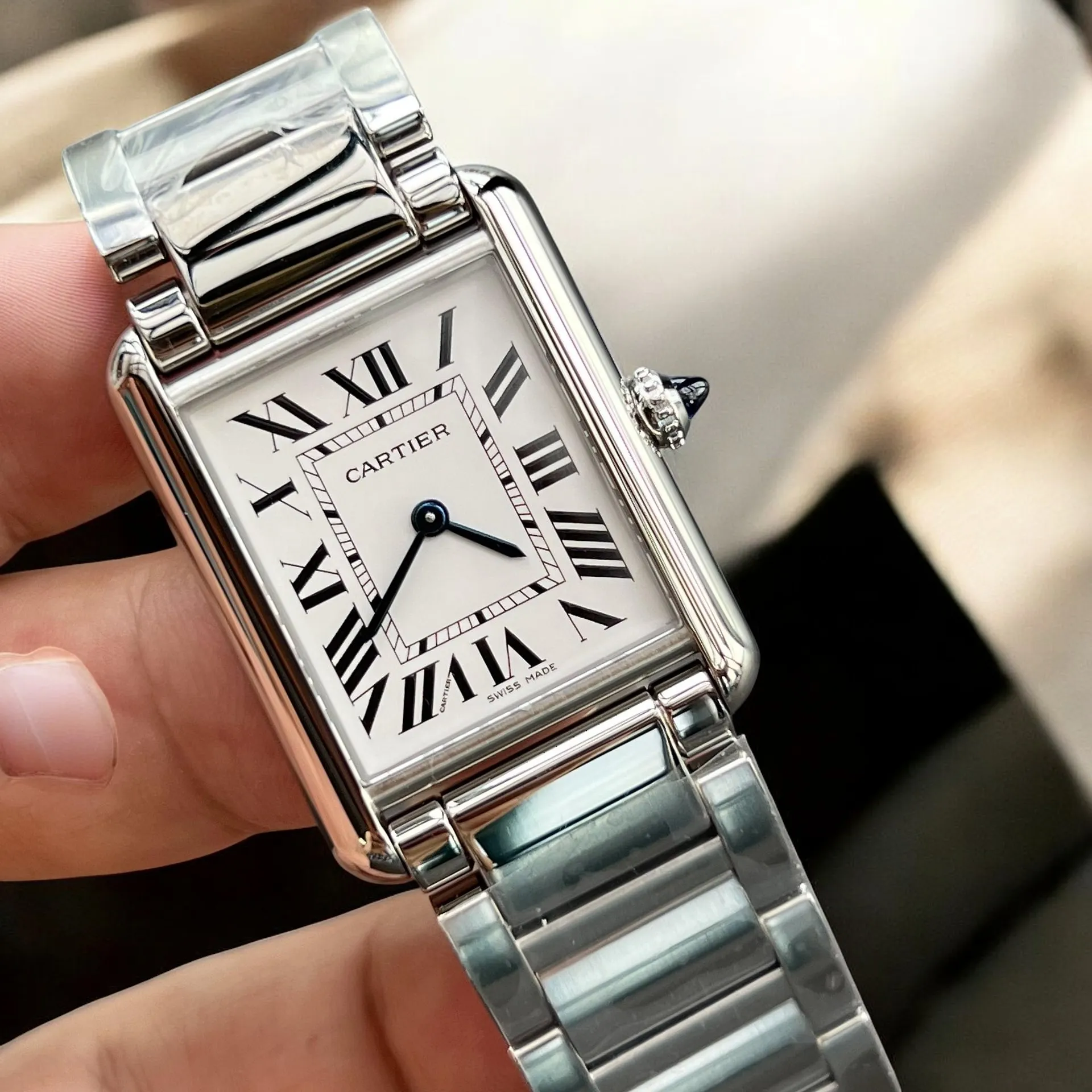 Detailed image focusing on the dial and stainless steel strap of the Cartier Tank Must watch dupe WSTA0052