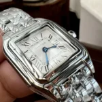 Close-up of the stainless steel case details of the Panthère de Cartier small model WSPN0013 watch dupe, highlighting its polished finish