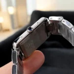 Side profile of the Cartier Tank Must Large stainless steel watch dupe, focusing on the beaded crown set with a synthetic cabochon-shaped spinel.