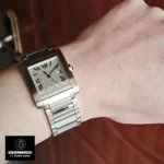 Wrist shot of 1:1 super clone Cartier watch with adjustable stainless steel bracelet, demonstrating ergonomic curved case design