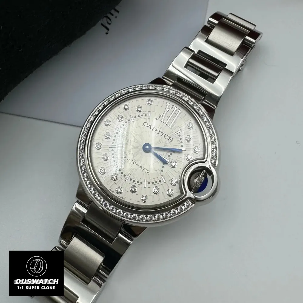 Cartier Ballon Bleu 33mm watch dupe with diamond dial lying flat on a table, emphasizing its sleek profile.