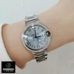 Cartier Ballon Bleu 33mm watch dupe with blue dial worn on wrist, illustrating its elegant appearance.