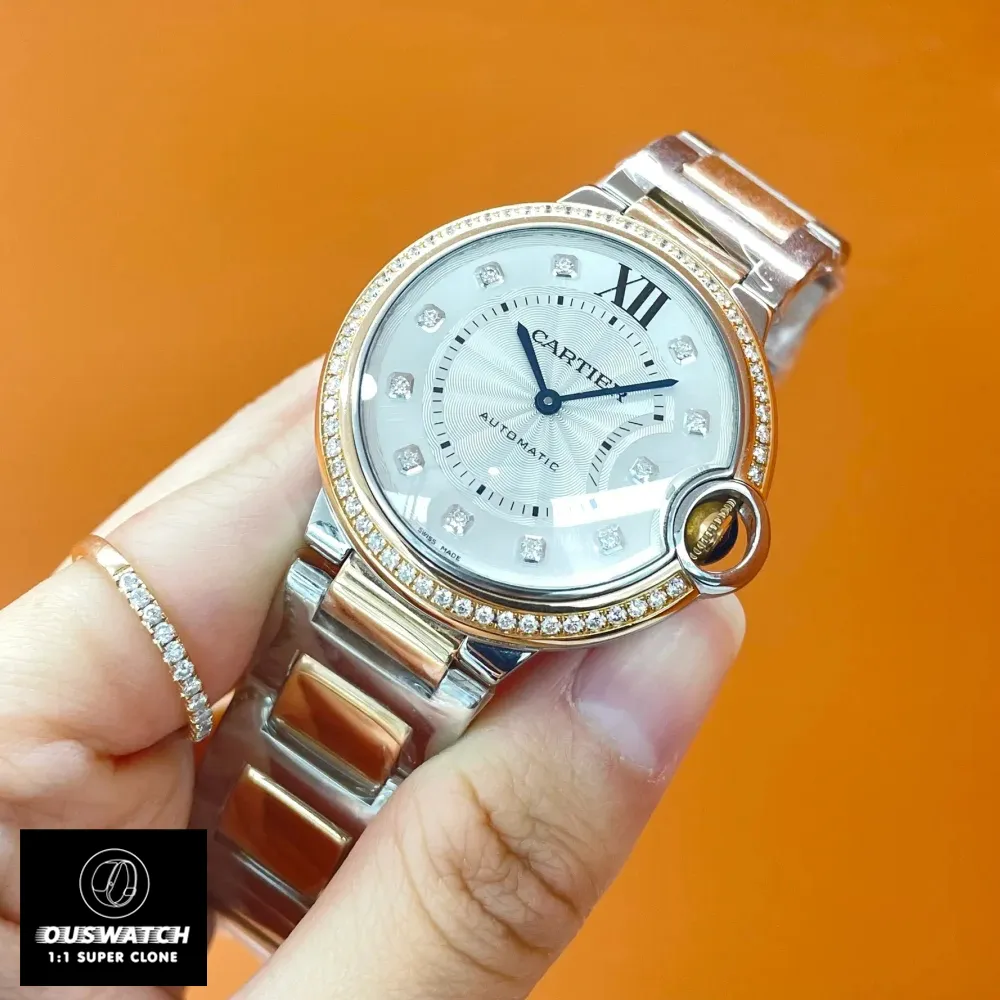Full view of the Cartier Ballon Bleu two-tone rose gold watch dupe, held in hand.