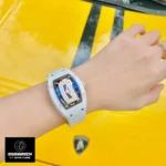 Wrist shot of the Richard Mille RM 07-01 white ceramic ladies watch replica, demonstrating ergonomic fit and luxury styling on a female model.
