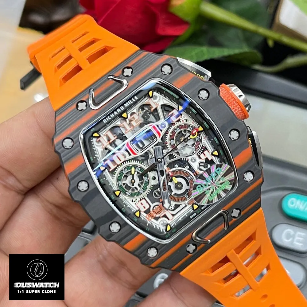 A 120° tilted view of the Richard Mille RM 11‑03 McLaren Automatic Flyback Chronograph, showcasing its skeletonized dial with the RMAC3 movement’s flyback chronograph module, 12‑hour totalizer, and oversized date window.