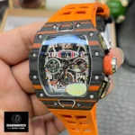 Richard Mille RM 11-03 carbon fiber case, dial and hands, paired with a yellow rubber strap.