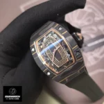 Extreme angled close-up of the RM 07-01’s skeletonized black onyx dial, revealing the CRMA2 automatic movement’s gear train and variable-geometry rotor. The depth of field captures the precision of the microblasted titanium bridges and the luminescent gold hands