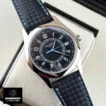 120-degree angled view of the Patek Calatrava 6007G-011, emphasizing the carbon fiber dial texture and color-matched blue stitching on the strap.