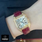 Cartier Santos Dumont gold watch elegantly worn on a woman's wrist, highlighting the harmony between the rose gold case and burgundy leather strap.