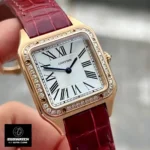 Close-up of the Cartier Santos Dumont women's watch dial, showcasing Roman numerals and blued-steel sword-shaped hands on a silver satin-brushed sunray-effect background.