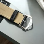 Close-up of Cartier Tank Must WSTA0042's black calfskin leather strap with stainless steel pin buckle, highlighting seamless integration with 29.5mm x 22mm case.