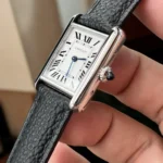 High-polish stainless steel case of Cartier Tank Must WSTA0042 with 6.6mm thickness, featuring signature screw-down case back and 30m water resistance.
